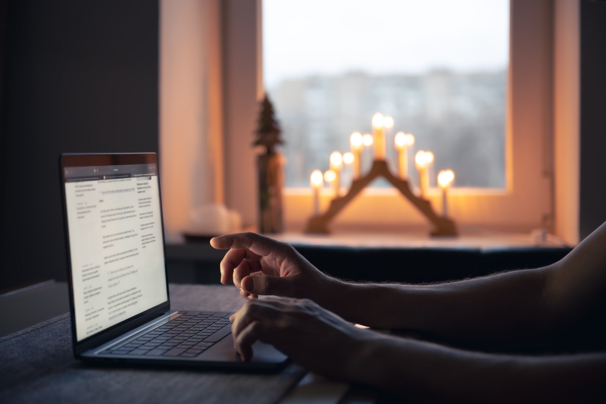 Property owner reviewing short-term rental performance on a laptop in the evening